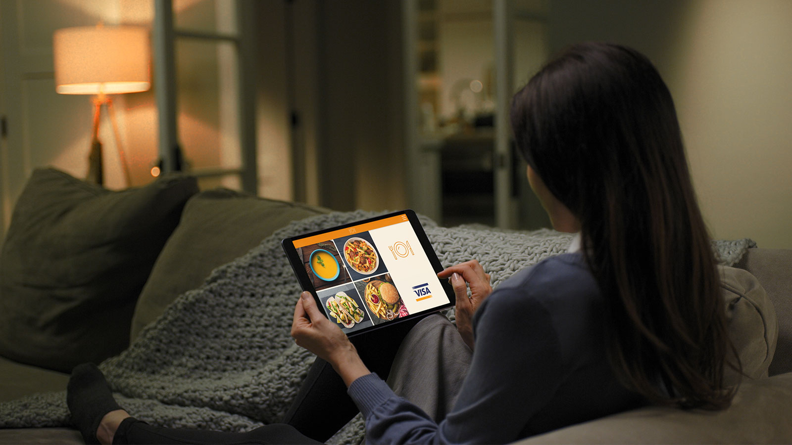 lady using tablet on couch